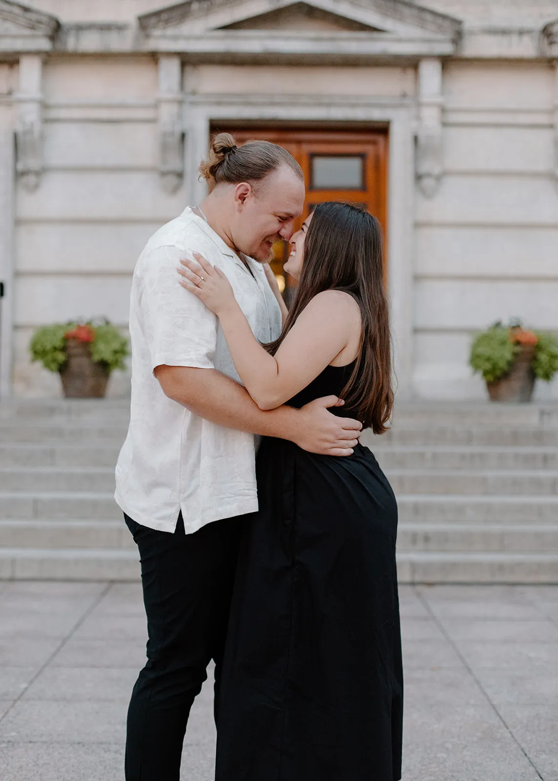Gina and Jacob nose to nose in front of a stone building