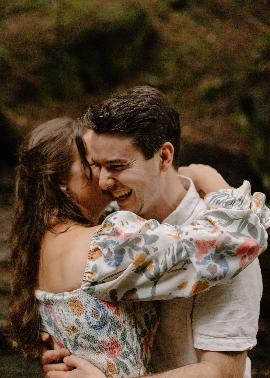 John laughing as Grace hugs him close